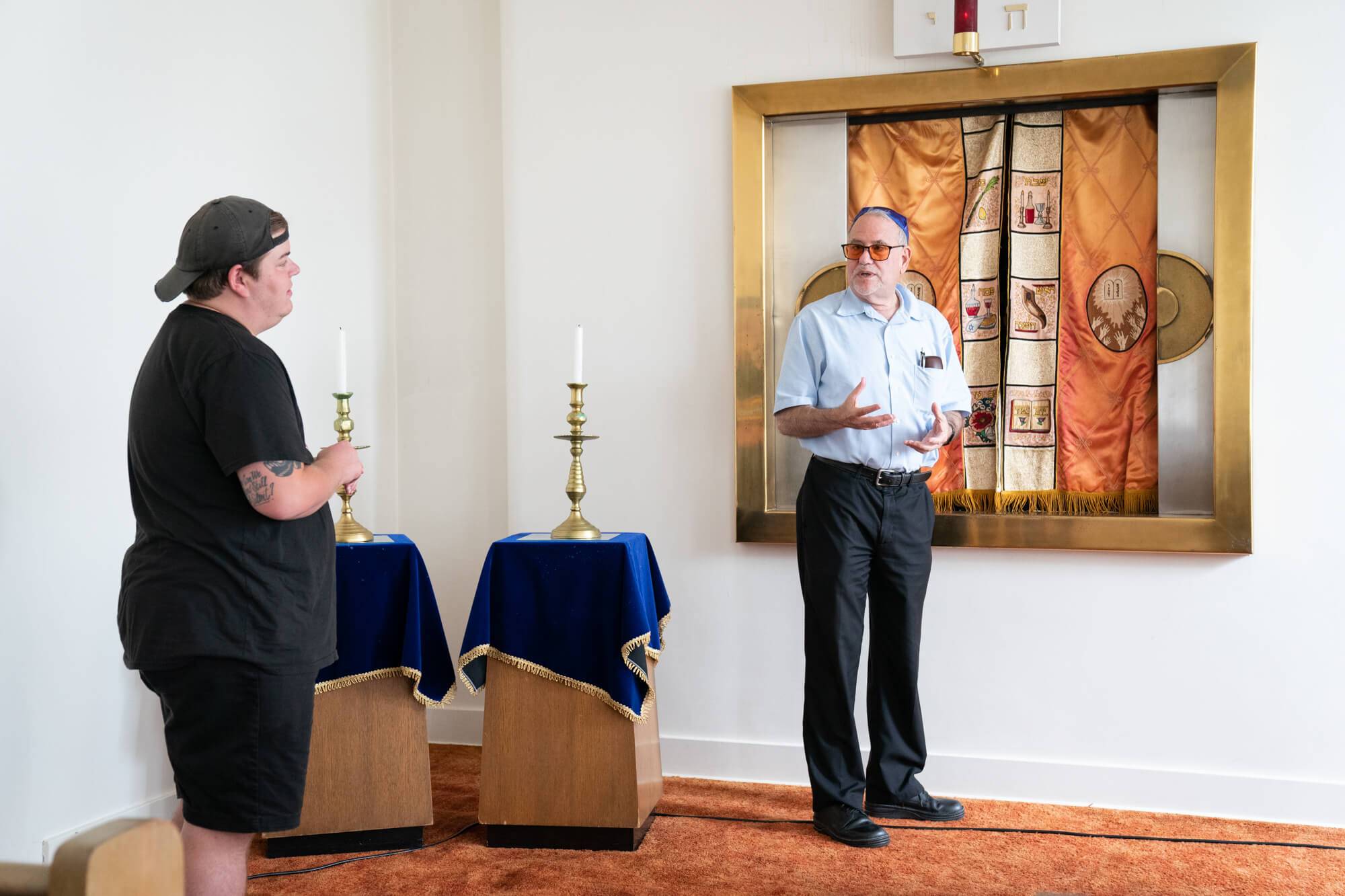 Joel Hill, left, talks with Rabbi Alan Alpert at the synagogue
